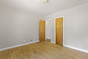 Denver apartment for rent - a empty room with a wooden floor and two doors